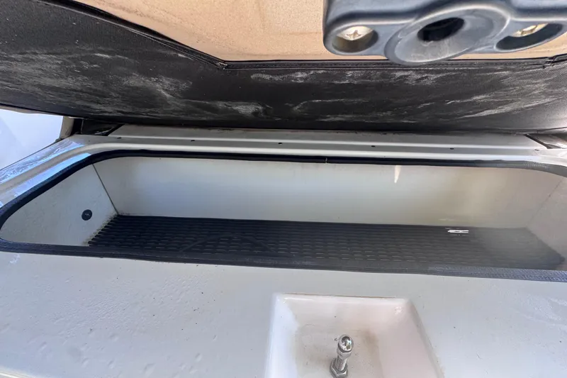 Slide: The Image of Open storage compartment on a 2015 Regal 28 Express boat. - 65