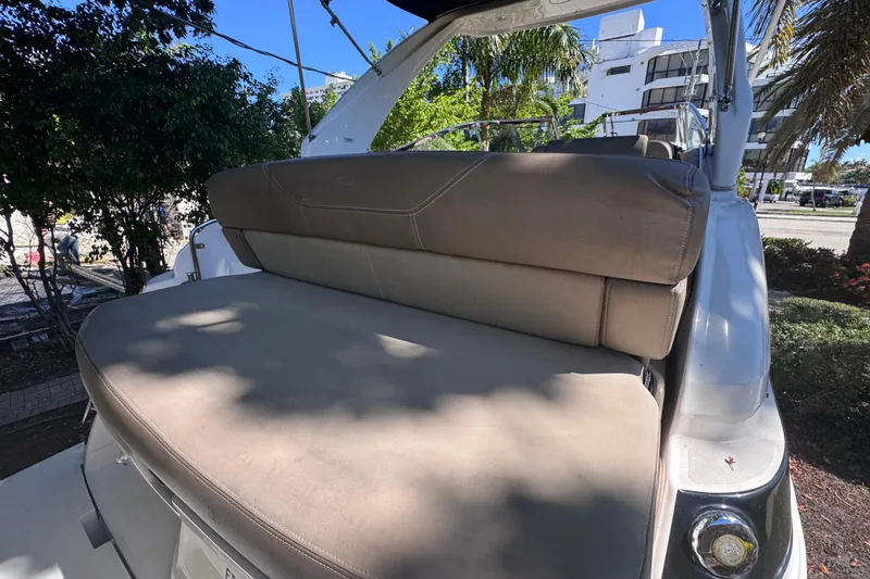 Slide: The Image of 2015 Regal 28 Express boat with beige seating, parked outdoors. - 66