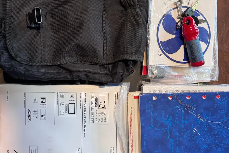 Slide: The Image of Assorted items including a black bag, documents, and keys on a table. Regal 28 Express 2015. - 80