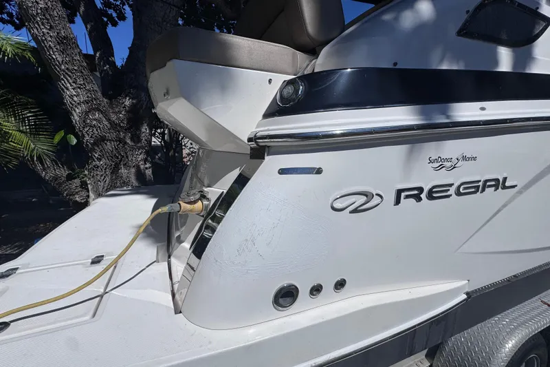 Slide: The Image of 2015 Regal 28 Express boat with power connection, parked outdoors. - 9