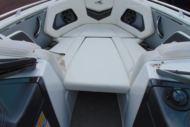 Slide: The Image of Interior of a 2015 Monterey 238SS boat with white seating and built-in speakers. - 10