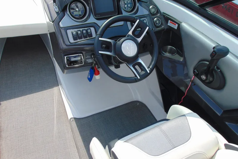 Slide: The Image of 2015 Monterey 238SS boat cockpit with steering wheel and control panel. - 13