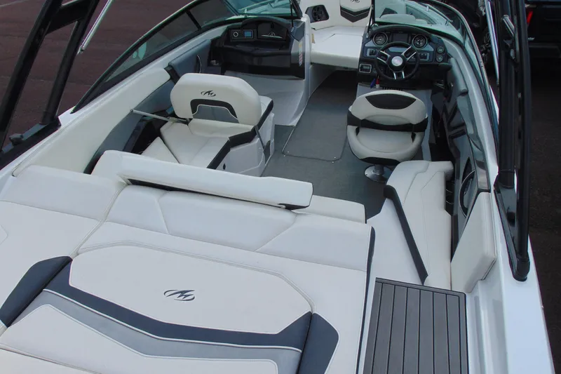 Slide: The Image of Interior of a 2015 Monterey 238SS boat with sleek white seating and modern dashboard. - 7
