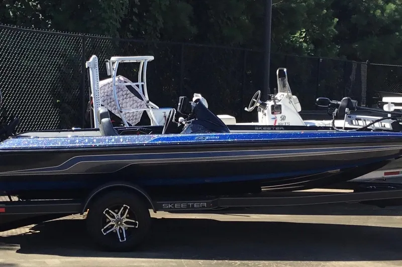 Slide: The Image of 2024 Skeeter ZX 150 boat on trailer, parked outdoors. - 0