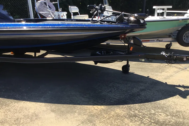 Slide: The Image of 2024 Skeeter ZX 150 boat on trailer, parked on concrete surface. - 1