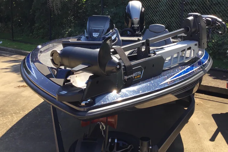 Slide: The Image of 2024 Skeeter ZX 150 boat with Minn Kota Ultrex trolling motor, parked outdoors. - 4