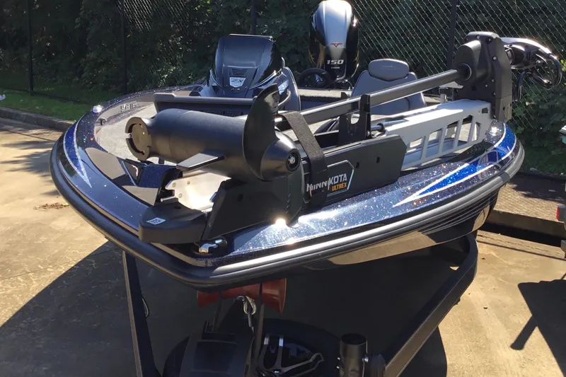 Slide: The Image of 2024 Skeeter ZX 150 boat with Minn Kota Ultrex motor, parked outdoors. - 6