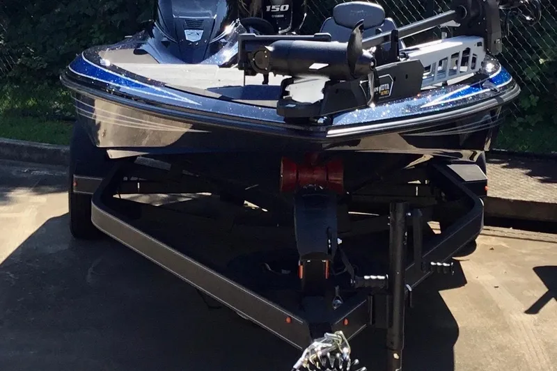 Slide: The Image of 2024 Skeeter ZX 150 boat on trailer, parked outdoors, front view. - 7