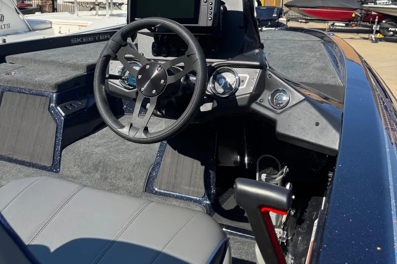 Slide: The Image of 2024 Skeeter ZX 150 boat interior with steering wheel and dashboard controls. - 8