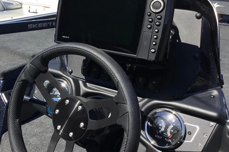 Slide: The Image of 2024 Skeeter ZX 150 boat dashboard with steering wheel and electronic display. - 9