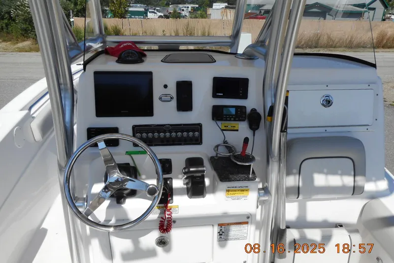 Slide: The Image of 2020 Sea Fox 249 Avenger boat dashboard with steering wheel and electronic controls. - 14