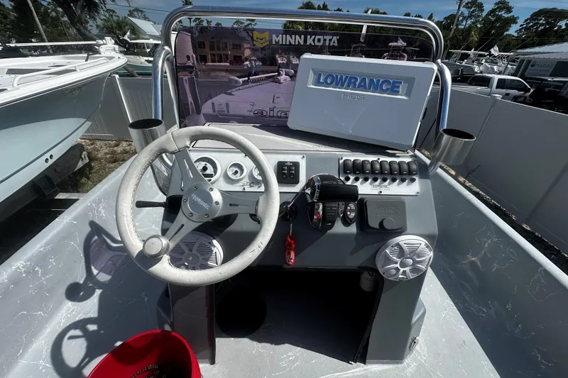 Slide: The Image of 2022 Haynie 25 Magnum boat dashboard with steering wheel and Lowrance HDS display. - 4