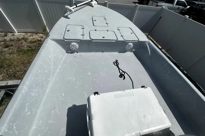 Slide: The Image of 2022 Haynie 25 Magnum boat deck with storage hatches and cooler. - 5