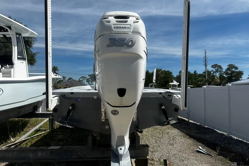 Slide: The Image of 2022 Haynie 25 Magnum boat with powerful 350 Verado engine, parked outdoors. - 9