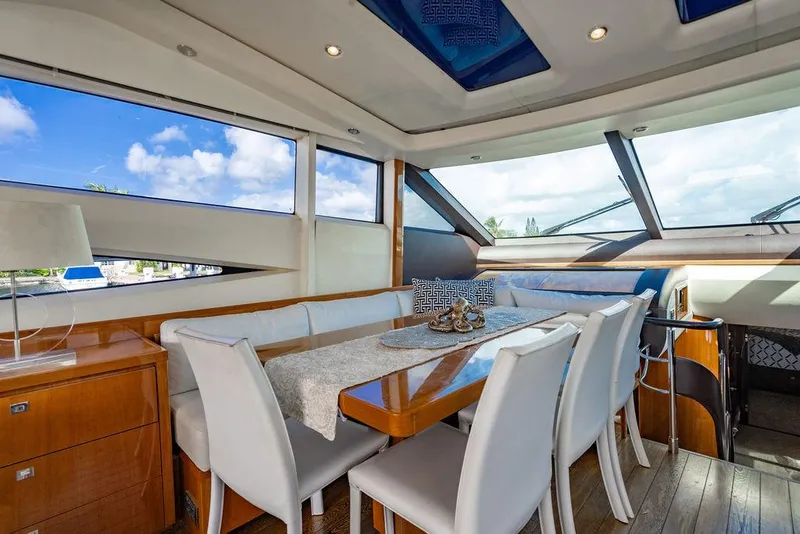 Slide: The Image of Luxurious interior of 2010 Princess V78 yacht with elegant dining area and panoramic windows. - 22
