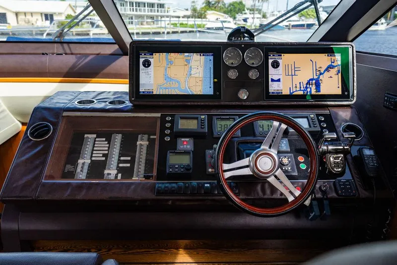 Slide: The Image of Control panel of 2010 Princess V78 yacht with navigation screens and steering wheel. - 27