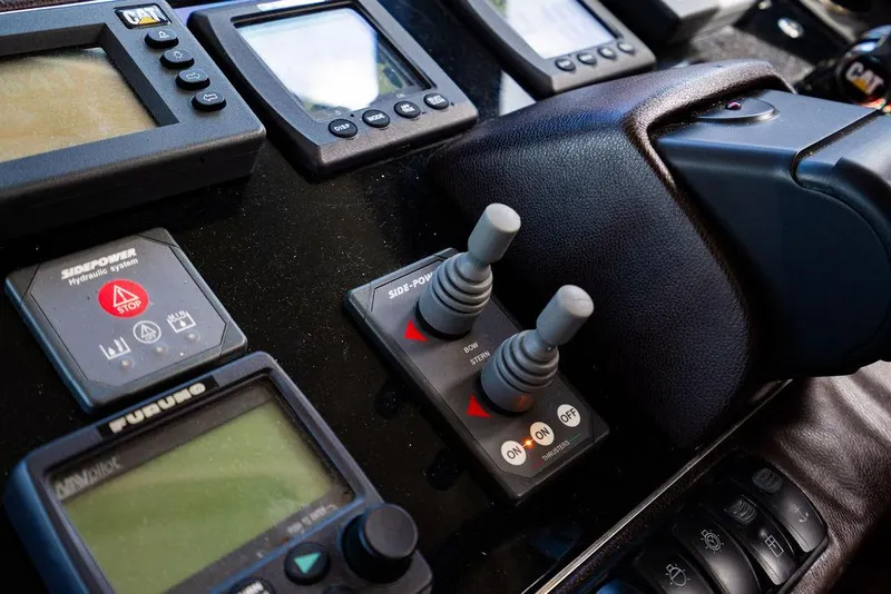 Slide: The Image of Control panel of a 2010 Princess V78 yacht with navigation instruments and joysticks. - 28