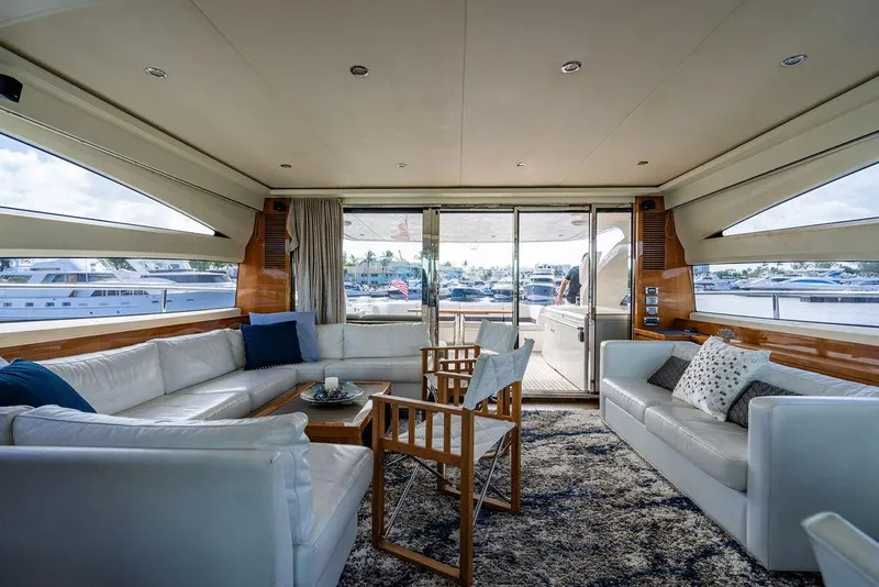 Slide: The Image of Luxurious interior of 2010 Princess V78 yacht with white seating and marina view. - 34