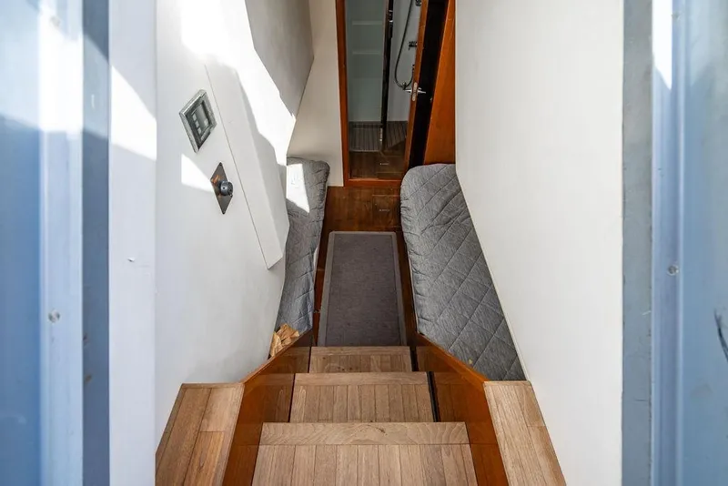 Slide: The Image of Interior staircase of 2010 Princess V78 yacht with wooden steps and cushioned walls. - 40