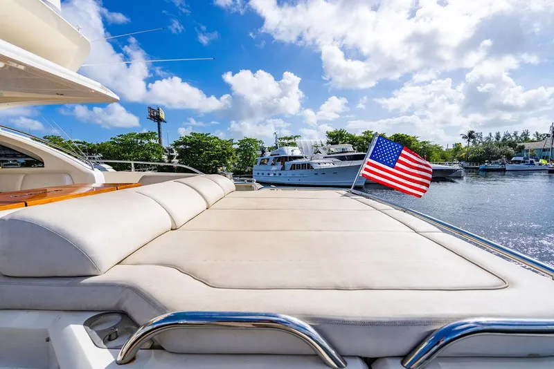 Slide: The Image of Luxury 2010 Princess V78 yacht with sun deck and American flag on a sunny day. - 48