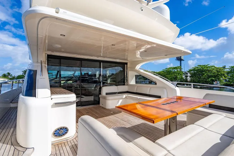 Slide: The Image of Luxurious 2010 Princess V78 yacht deck with seating and table under blue sky. - 49