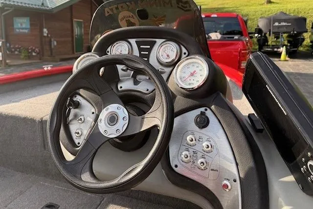 Slide: The Image of 2015 Tracker Pro Team 175TXW boat dashboard with steering wheel and gauges. - 11