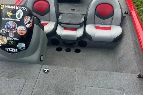 Slide: The Image of 2015 Tracker Pro Team 175TXW boat interior with red and gray seating and dashboard stickers. - 4