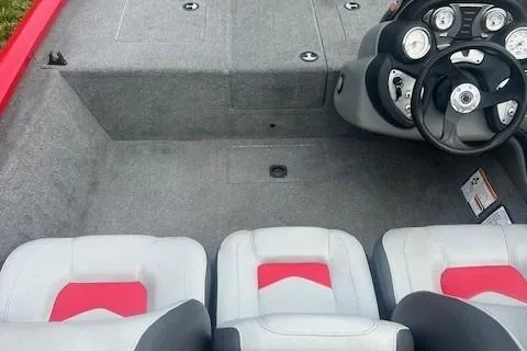 Slide: The Image of 2015 Tracker Pro Team 175TXW boat interior with gray and red seating, steering console. - 7