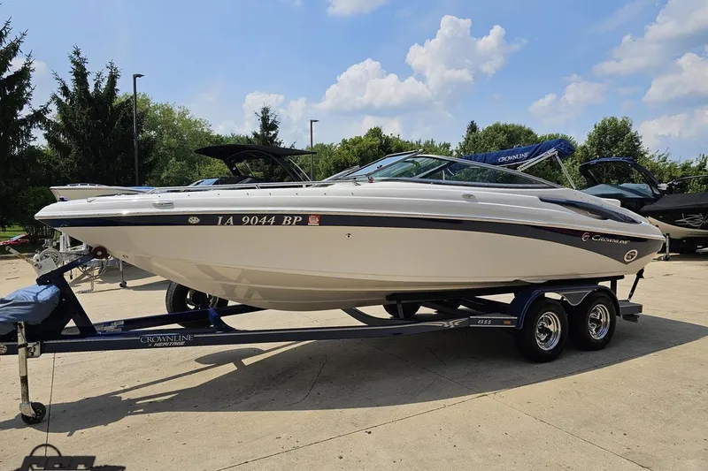 Slide: The Image of 2007 Crownline 23 SS boat on trailer, parked outdoors under a clear sky. - 15