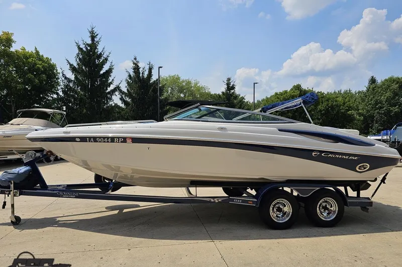 Slide: The Image of 2007 Crownline 23 SS boat on trailer, parked outdoors under a clear sky. - 16