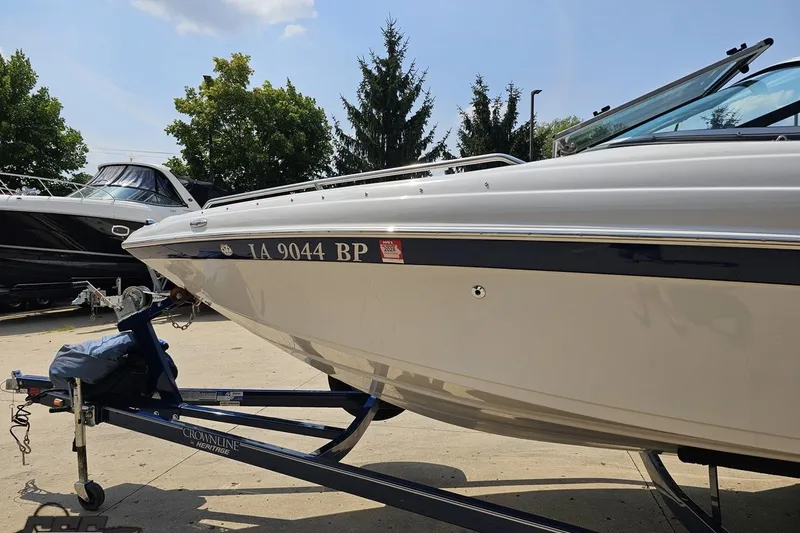 Slide: The Image of 2007 Crownline 23 SS boat on trailer, parked outdoors under clear sky. - 18