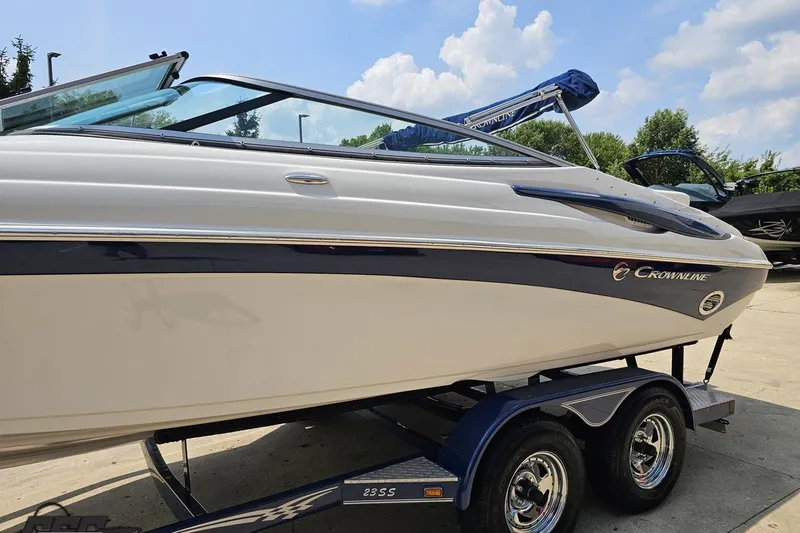 Slide: The Image of 2007 Crownline 23 SS boat on trailer, sleek design, sunny day background. - 19