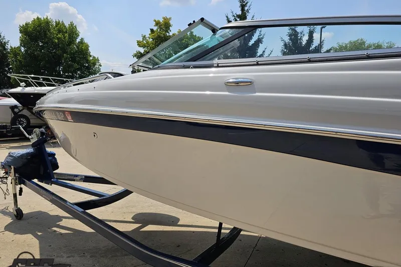 Slide: The Image of 2007 Crownline 23 SS boat on trailer, sleek design, sunny day, outdoor setting. - 22