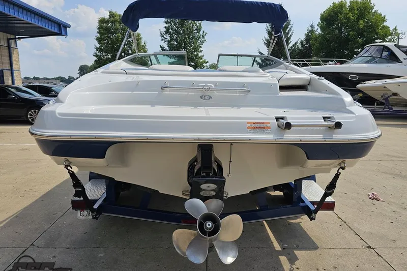 Slide: The Image of 2007 Crownline 23 SS boat, rear view with propeller, parked outdoors. - 28