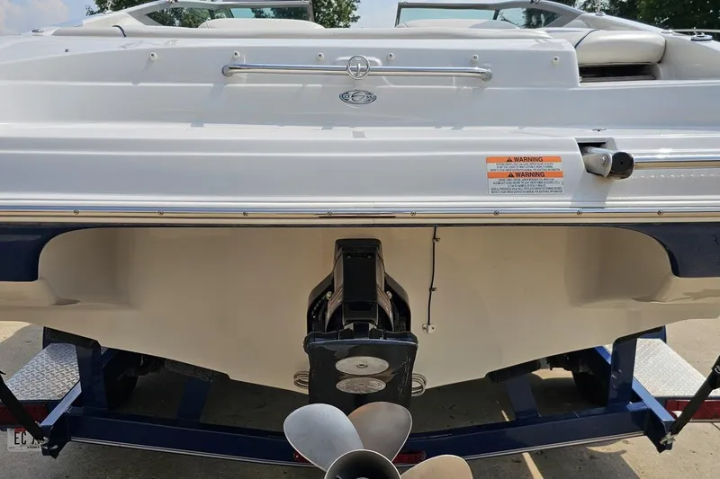 Slide: The Image of Rear view of a 2007 Crownline 23 SS boat with visible propeller and warning labels. - 29