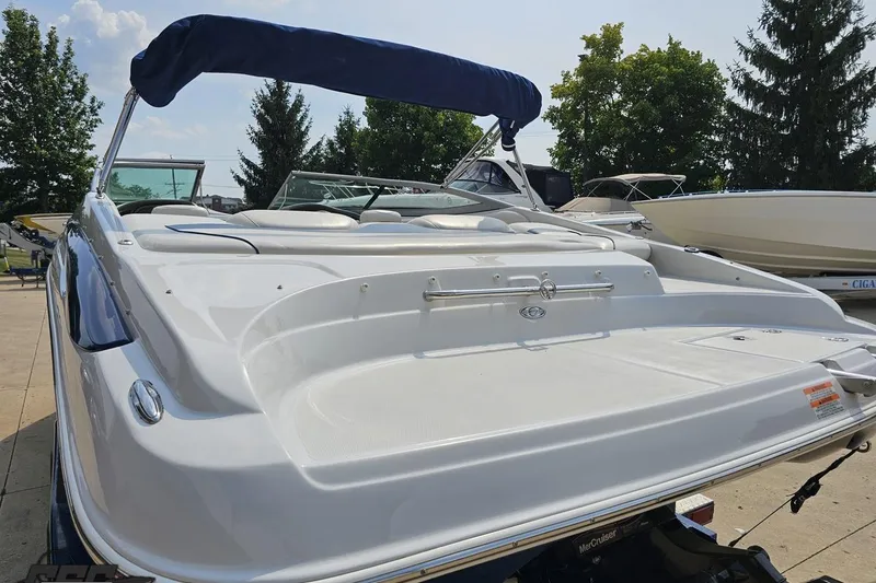 Slide: The Image of 2007 Crownline 23 SS boat with blue canopy, parked outdoors. - 31