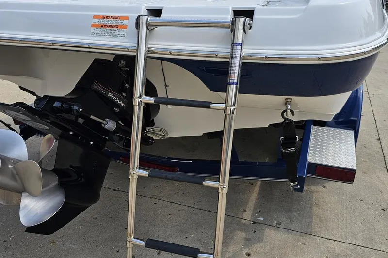 Slide: The Image of 2007 Crownline 23 SS boat stern with ladder and propeller on trailer. - 32