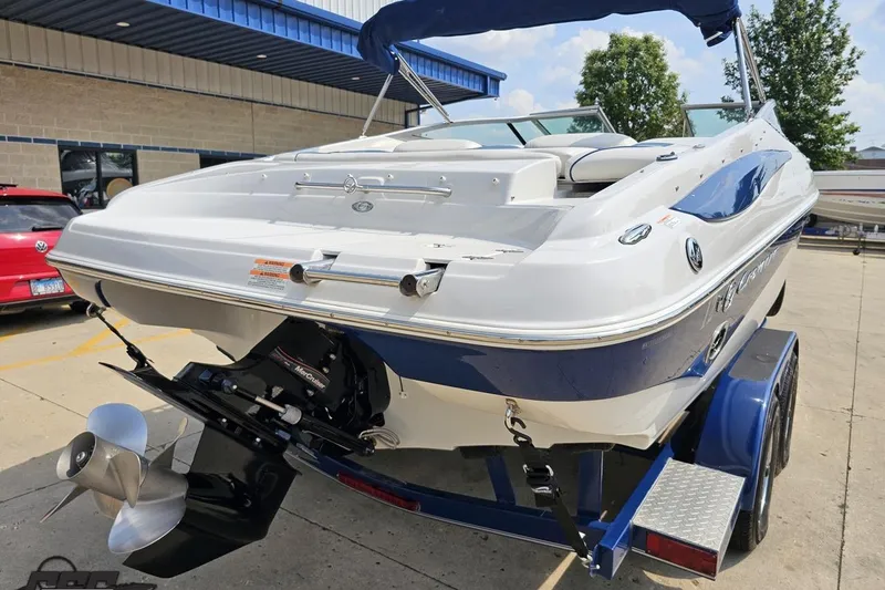 Slide: The Image of 2007 Crownline 23 SS boat on trailer, displayed outdoors near a building. - 35
