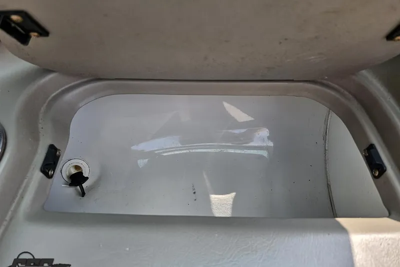 Slide: The Image of Storage compartment of a 2007 Crownline 23 SS boat, featuring a key lock. - 50