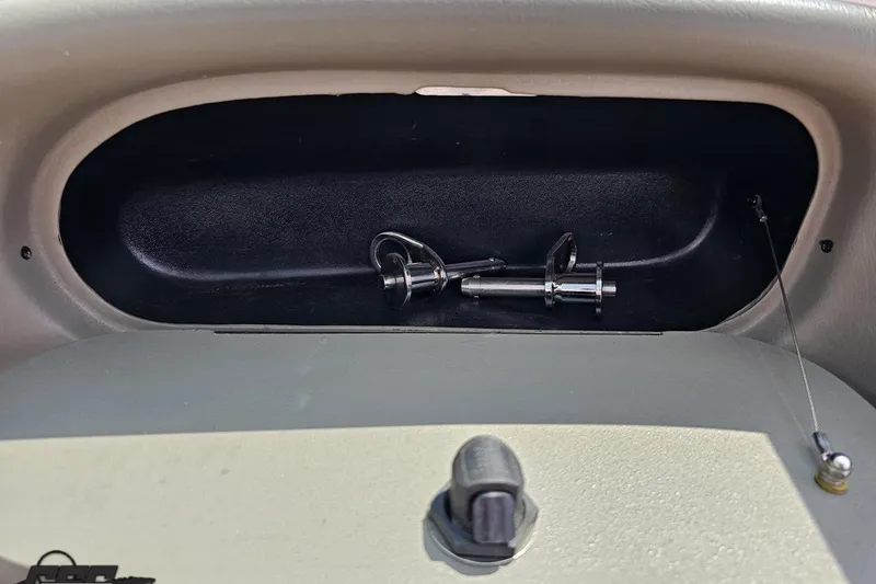Slide: The Image of 2007 Crownline 23 SS boat dashboard compartment with metal hardware inside. - 51