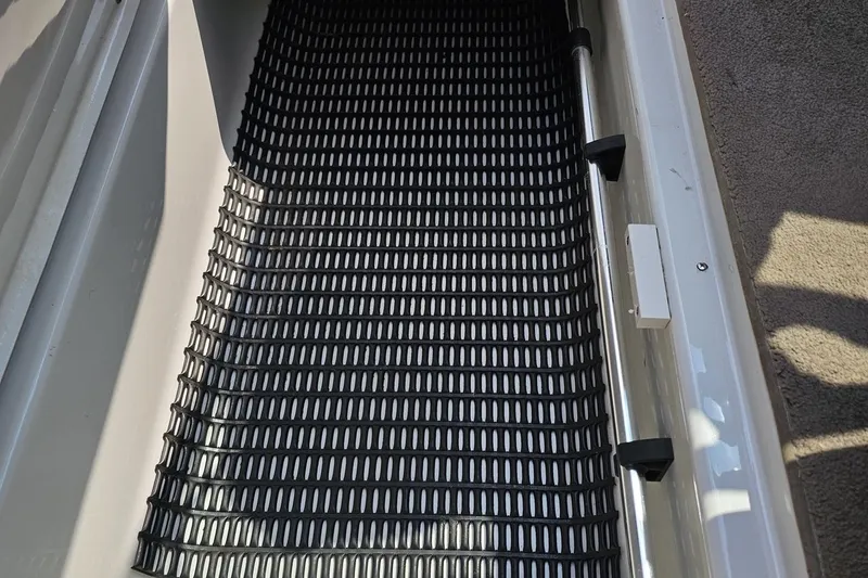 Slide: The Image of 2007 Crownline 23 SS boat storage compartment with black non-slip mat. - 52