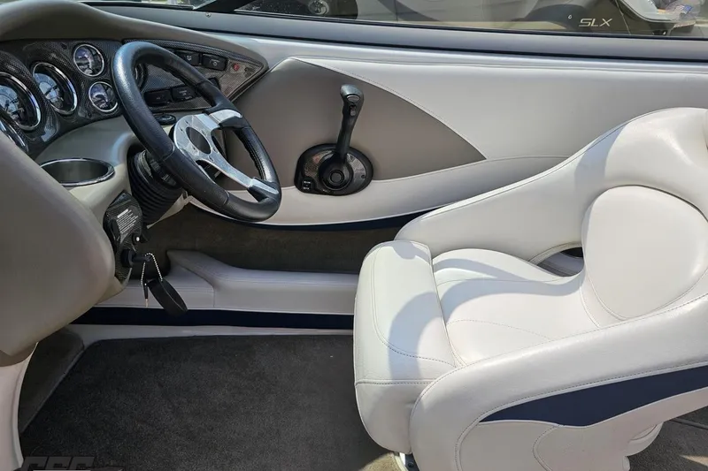 Slide: The Image of 2007 Crownline 23 SS boat interior with steering wheel and white seating. - 53