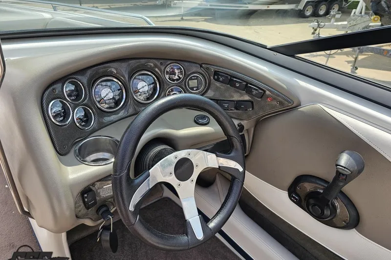 Slide: The Image of 2007 Crownline 23 SS boat dashboard with steering wheel and instrument panel. - 56