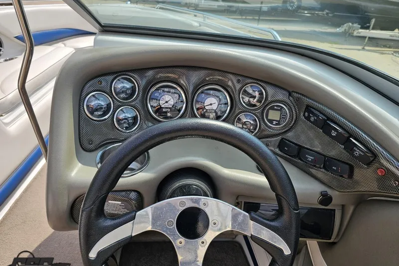 Slide: The Image of Dashboard of a 2007 Crownline 23 SS boat with gauges and steering wheel. - 58