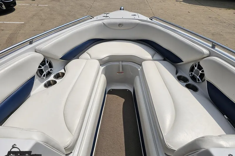 Slide: The Image of 2007 Crownline 23 SS boat interior with white and blue seating, cup holders, and speakers. - 63