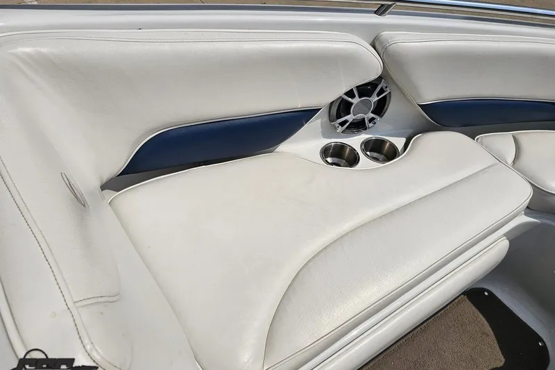 Slide: The Image of 2007 Crownline 23 SS boat interior with white seating, speaker, and cup holders. - 65