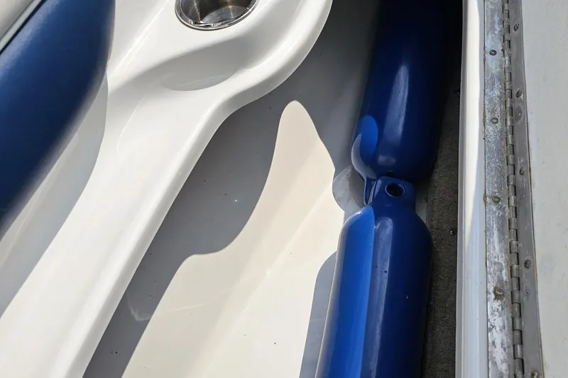 Slide: The Image of 2007 Crownline 23 SS boat interior with blue fenders and cup holder. - 66