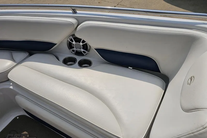 Slide: The Image of 2007 Crownline 23 SS boat interior with white seating, speaker, and cup holders. - 67