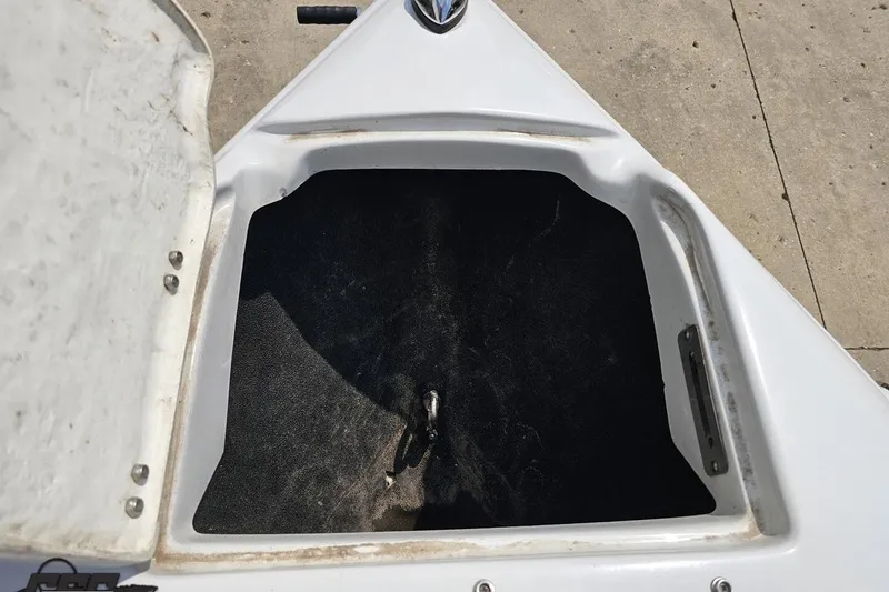 Slide: The Image of Open storage compartment on a 2007 Crownline 23 SS boat, showing interior space. - 73