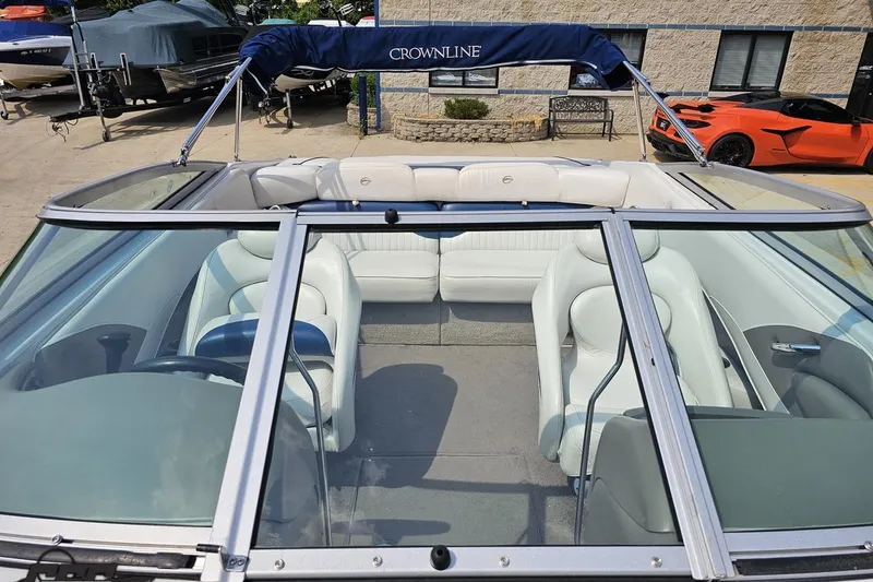 Slide: The Image of 2007 Crownline 23 SS boat interior with white seating and blue canopy. - 75